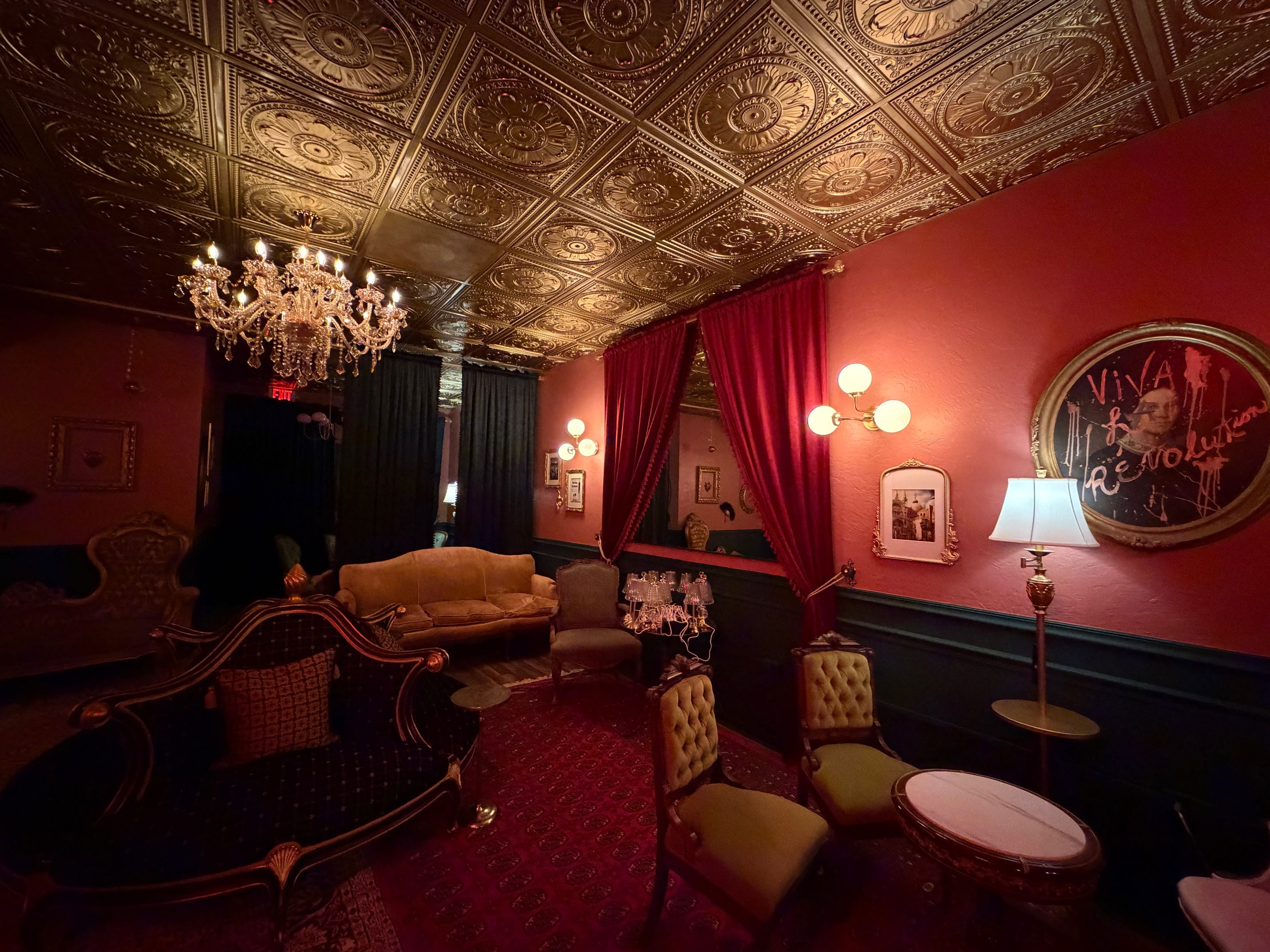 Mimi's Brasserie red lounge interior with ornate ceiling and chandelier